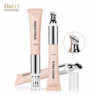 Matte pink PE cosmetic tube with human induction vibrating metal massage tip eye lip skincare tube white background