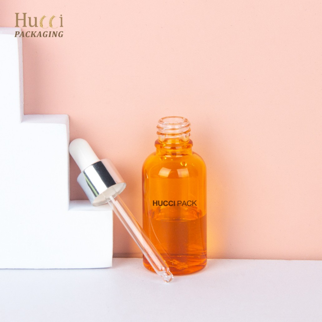 Elegant 30ml orange glass serum dropper bottle studio photography for skincare packaging}